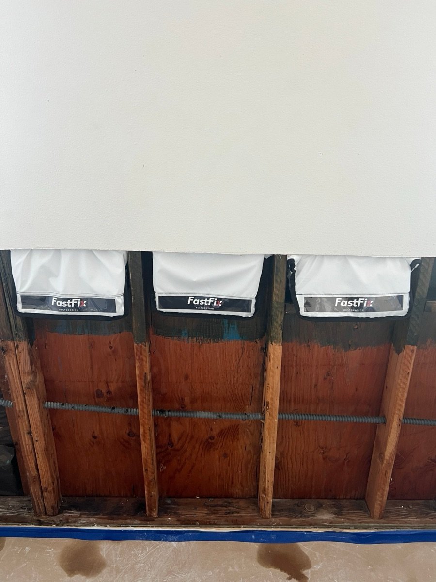 Wall opened at the bottom with drying pockets drying the wall cavities in a Santa Monica condo