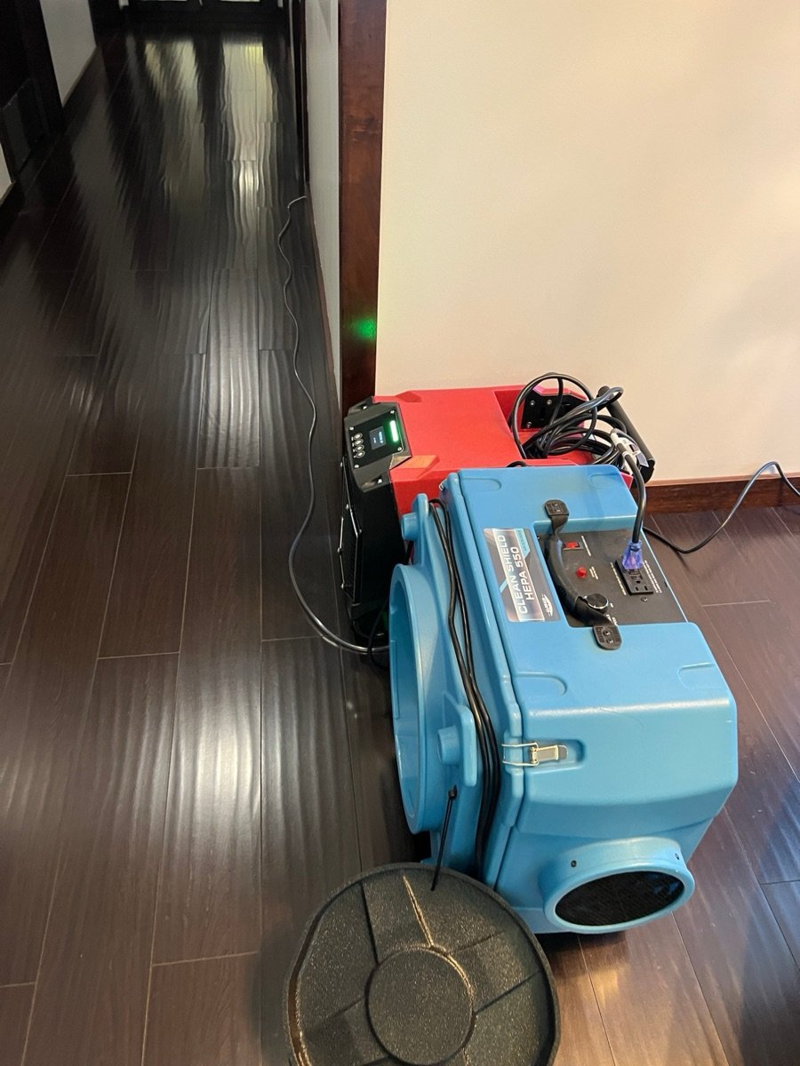 HEPA air scrubber and dehumidifier drying a medical office hallway