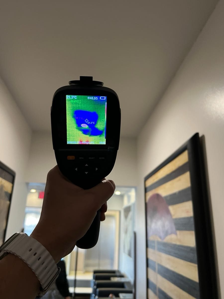 Thermal camera showing a wet area on a medical office hallway ceiling after a pipe burst on the floor above