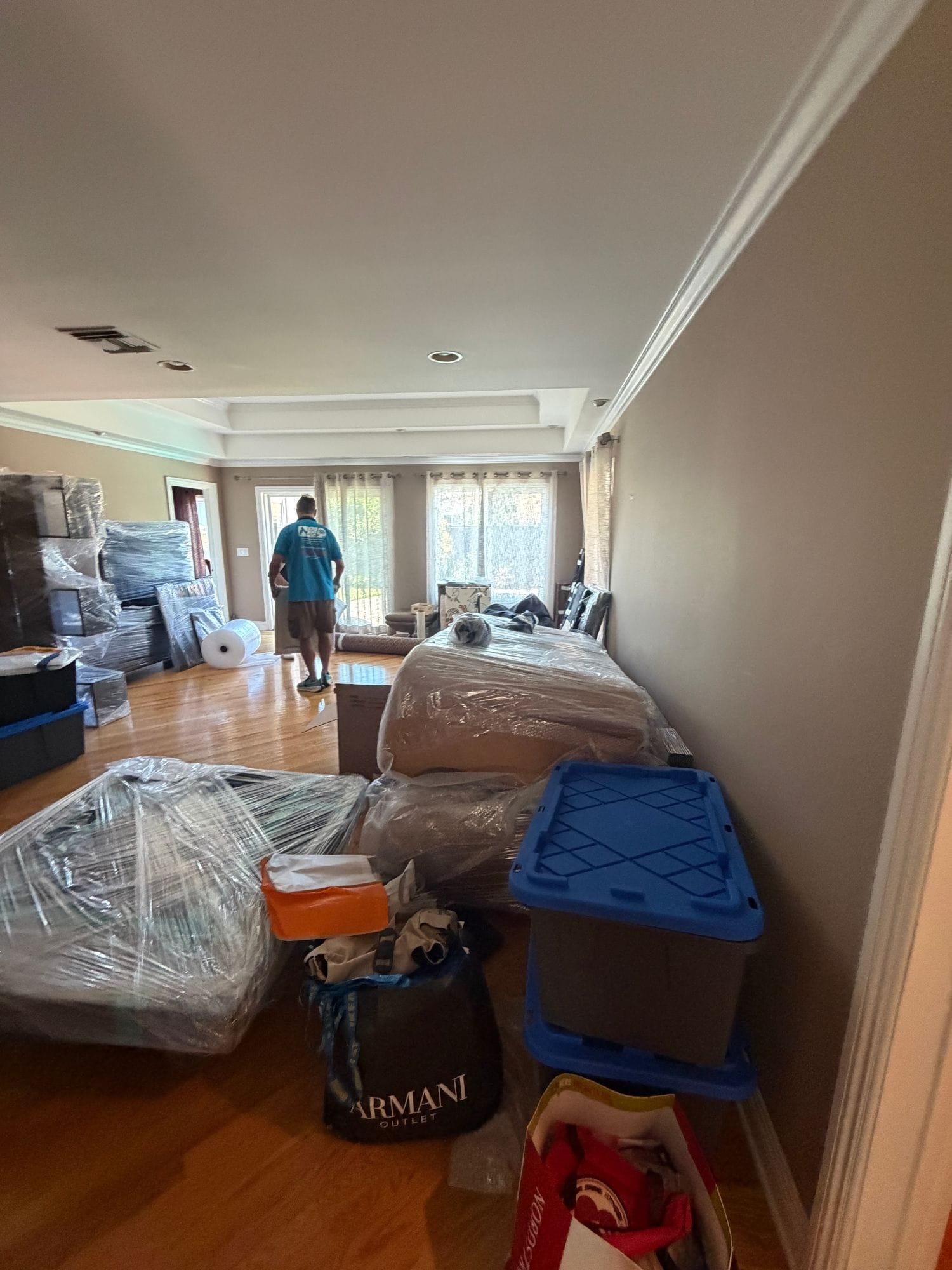 FastFix crew wrapping and packing out furniture and belongings before restoration