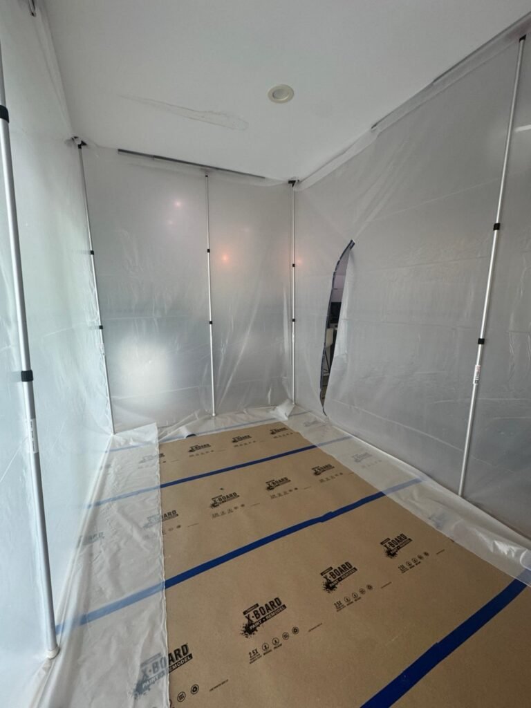 Plastic containment and floor protection set up before work in a Hollywood Hills home