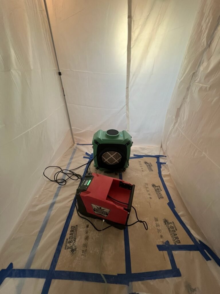 Dehumidifier and HEPA air scrubber running inside containment after a toilet leak in the Hollywood Hills