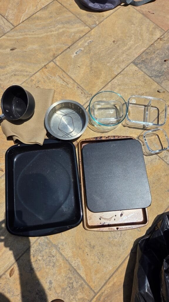 Kitchen cookware laid out and photographed one by one during contents cleaning in Pacific Palisades