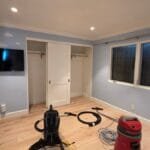 HEPA vacuums in an emptied bedroom during smoke and ash cleaning in a Pacific Palisades home