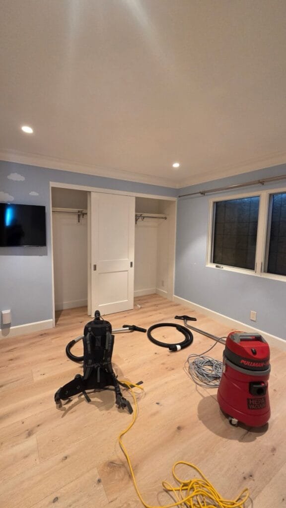 HEPA vacuums in an emptied bedroom during smoke and ash cleaning in a Pacific Palisades home