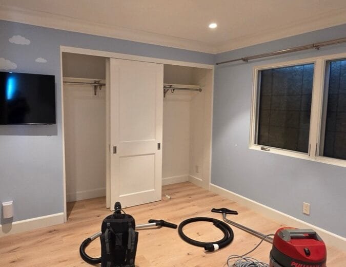 HEPA vacuums in an emptied bedroom during smoke and ash cleaning in a Pacific Palisades home