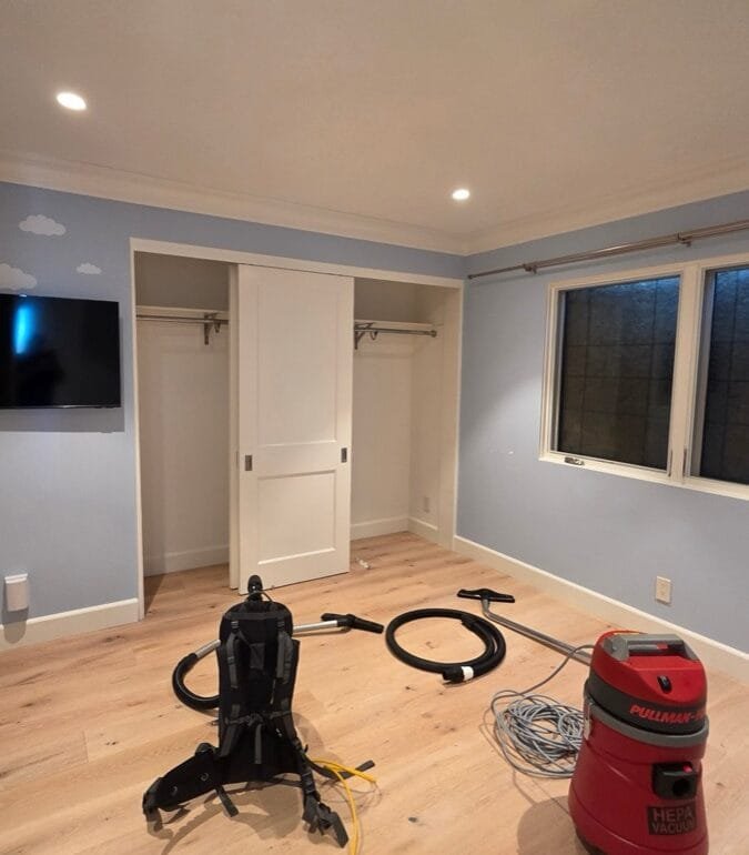 HEPA vacuums in an emptied bedroom during smoke and ash cleaning in a Pacific Palisades home