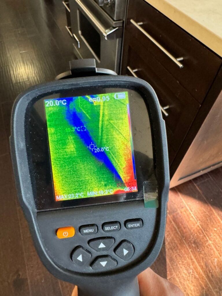 Thermal camera showing a wet line along the kitchen cabinet base after a refrigerator line leak in Sherman Oaks